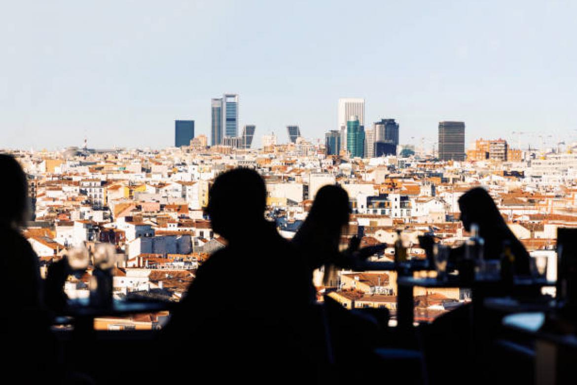 Social gathering in Madrid center with the views of the business district of Madrid. Spain.