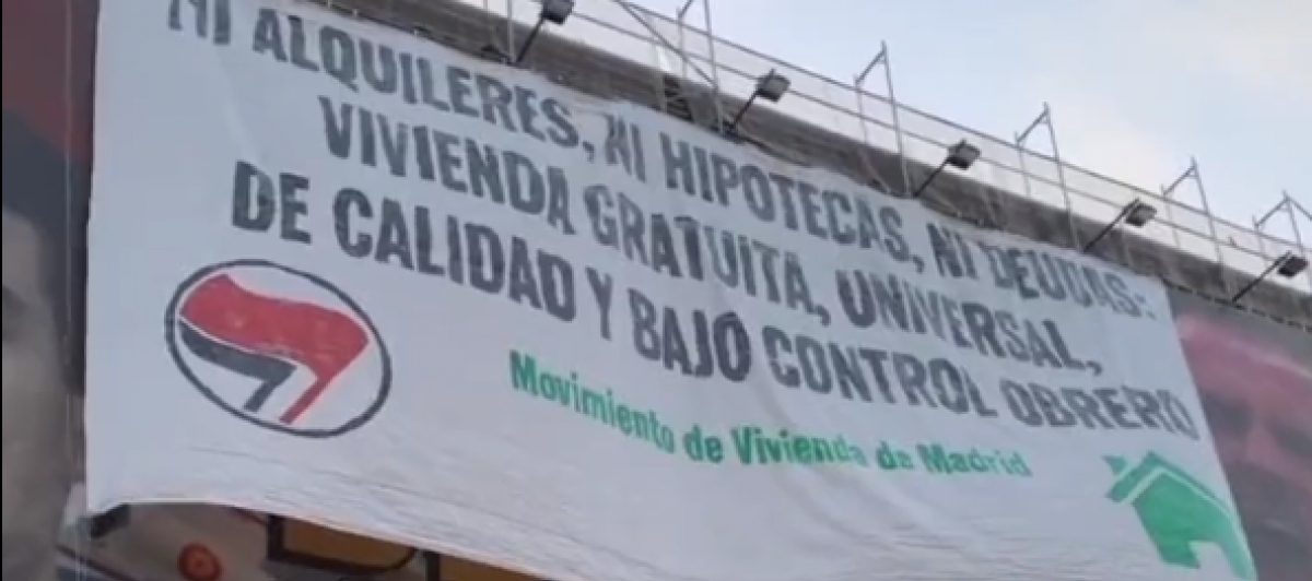Instante en que se despliega la pancarta sobre la lona de Desokupa.