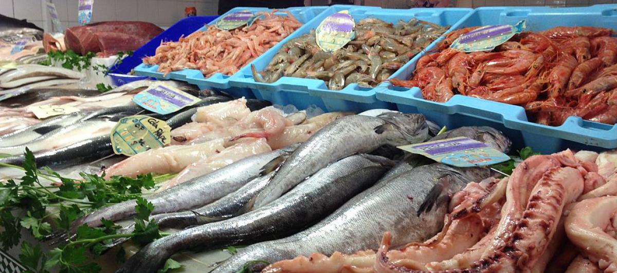 Un pescadero ofrece marisco y pescado.