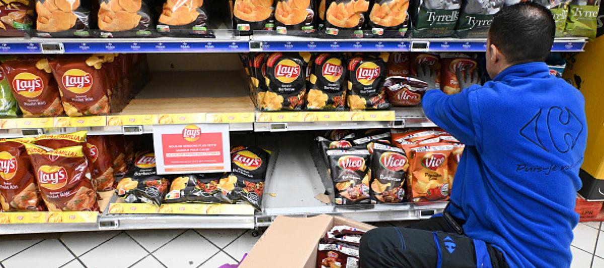 Imagen de archivo de un trabajador de Carrefour en París retirando productos de PepsiCo de los estantes.