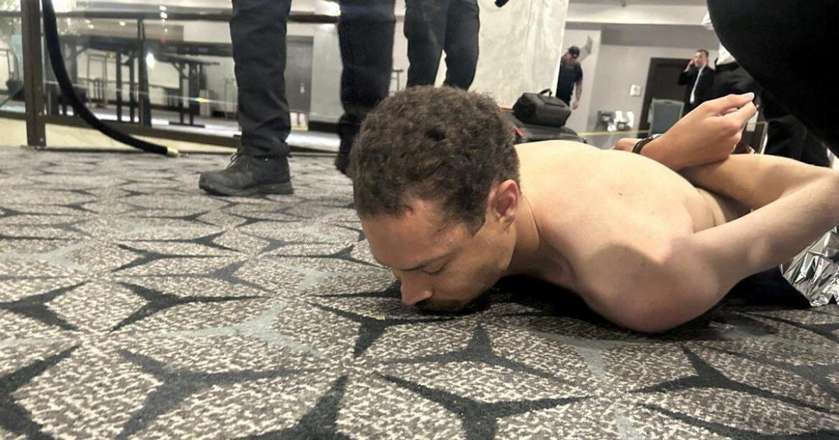 Law enforcement personnel detain Cole Tomas Allen, a suspect in the shooting incident at the White House Correspondents' Association dinner, in Washington, D.C., U.S. April 25, 2026. DONALD J TRUMP via Truth Social/Handout via REUTERS    THIS IMAGE HAS BEEN SUPPLIED BY A THIRD PARTY. MANDATORY CREDIT. REFILE - ADDING NAME OF THE SUSPECTED SHOOTER  VERIFICATION: Reuters was able to verify the location from flooring and windows that match corroborating footage. Date confirmed from the government statement of the incident. No old results were posted online before April 25. FBI confirmed that National Capital Response Squad has responded to a shooting at the Washington Hilton and added that the subject is in custody.