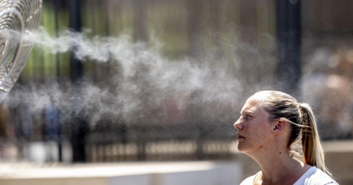 Una joven intenta refrescarse cerca del Coliseo romano en agosto de 2022