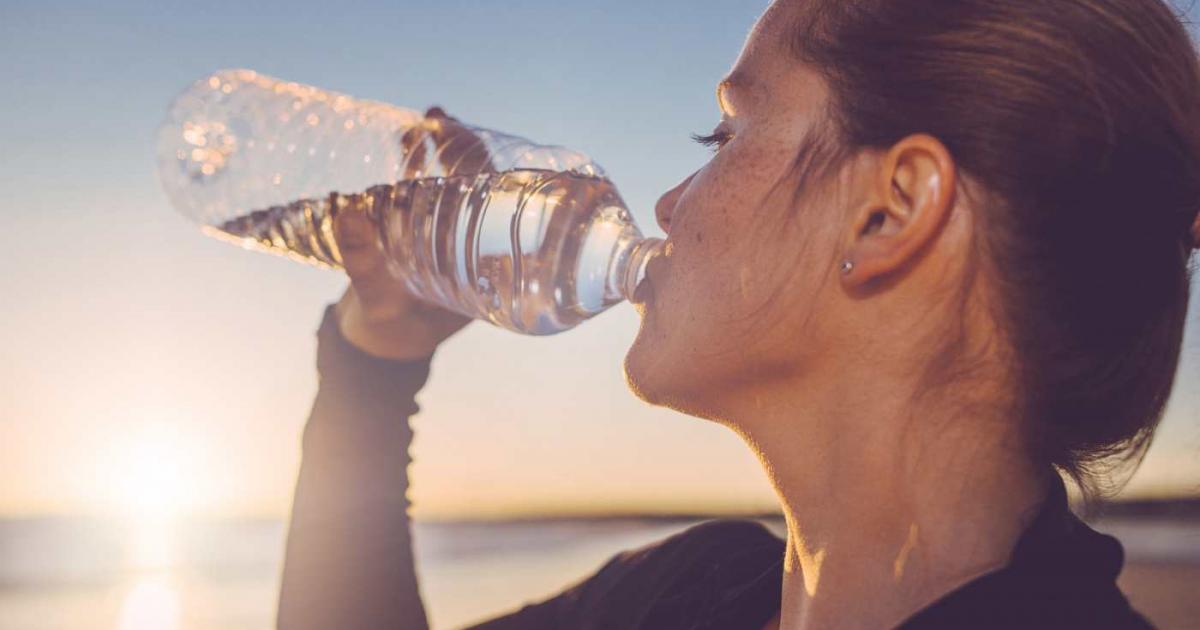 Mujer bebiendo agua embotellada
