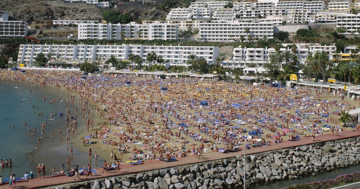 Panorámica de una playa de Gran Canaria abarrotada de turistas.