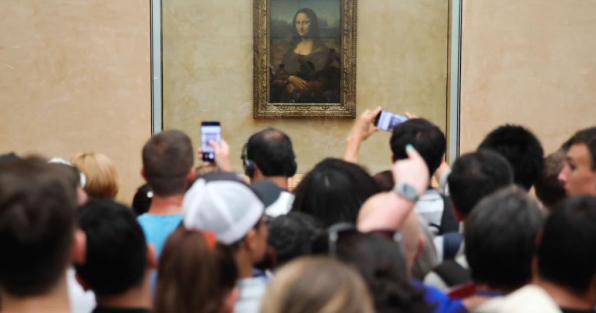 Visitantes del Louvre fotografiando la Mona Lisa.