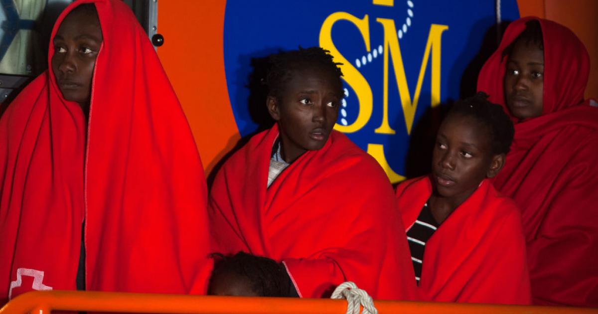 GRANADA, SPAIN - 2020/12/14: Sub-Saharan migrant children who were rescued from a dinghy at the Mediterranean Sea, are seen standing on a rescue boat with their children on their arrival at the Port of Motril. 
Un grupo de personas migrantes subsaharianas, entre ellas menores, a su llegada al puerto de Motril (Granada) tras ser rescatadas por Salvamento Marítimo, el 14 de diciembre de 2020.