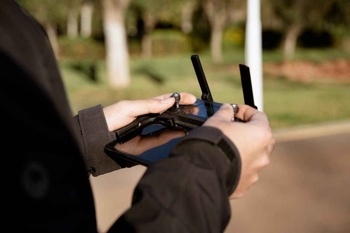 Una persona controlando un dron mediante un joystick.