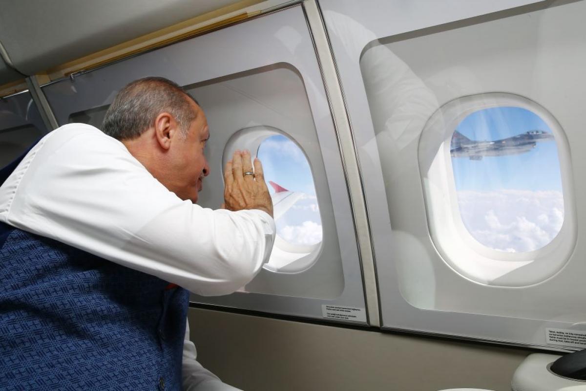 El presidente turco, Recep Tayyip Erdogan, siendo saludado por un piloto turco sobre un caza F-16.