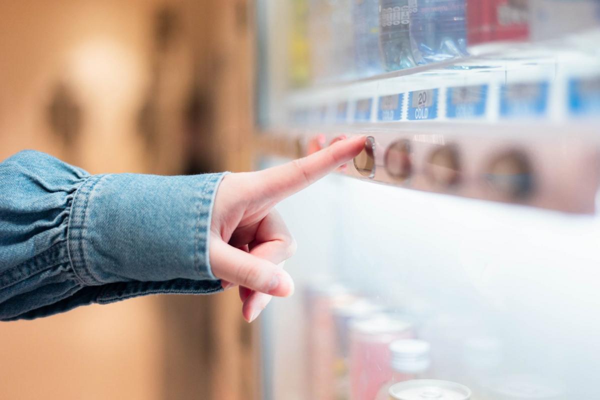 Persona comprando una bebida en una maquina