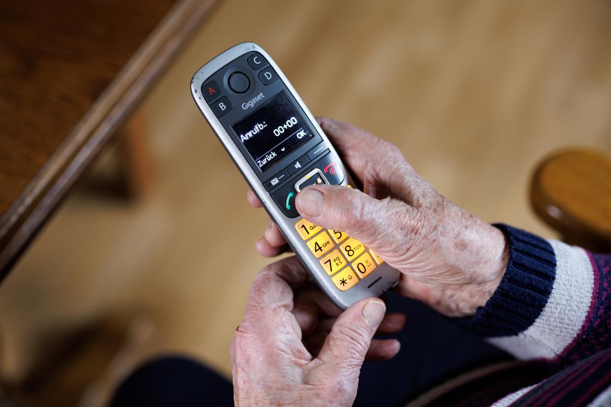 Una persona mayor con un teléfono.