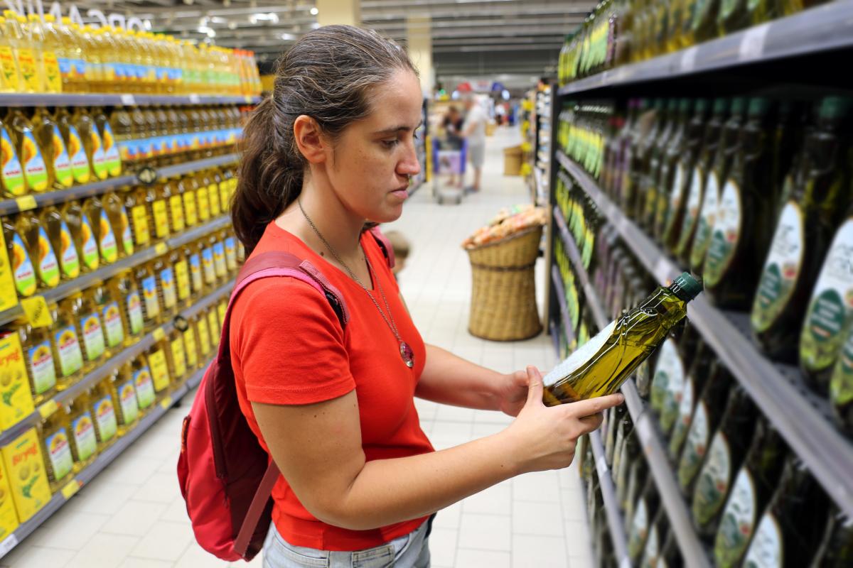 Una clienta, interesada en el contenido nutricional del aceite de oliva virgen extra.