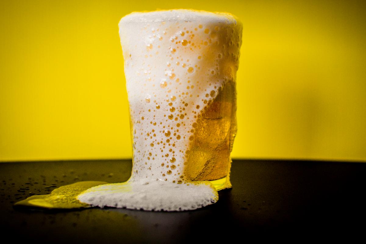 Una cerveza rebosando espuma.