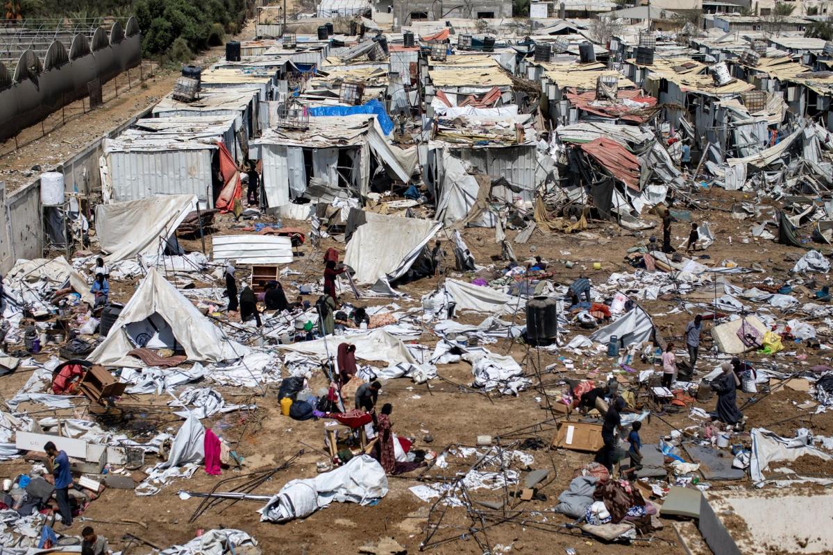 Palestinos desplazados inspeccionan las tiendas de campaña destruidas después de un ataque israelí en el campamento de Al-Manasrah, que albergaba a más de 200 familias en Deir al-Balah, en el centro de la Franja de Gaza, el 21 de agosto de 2025.