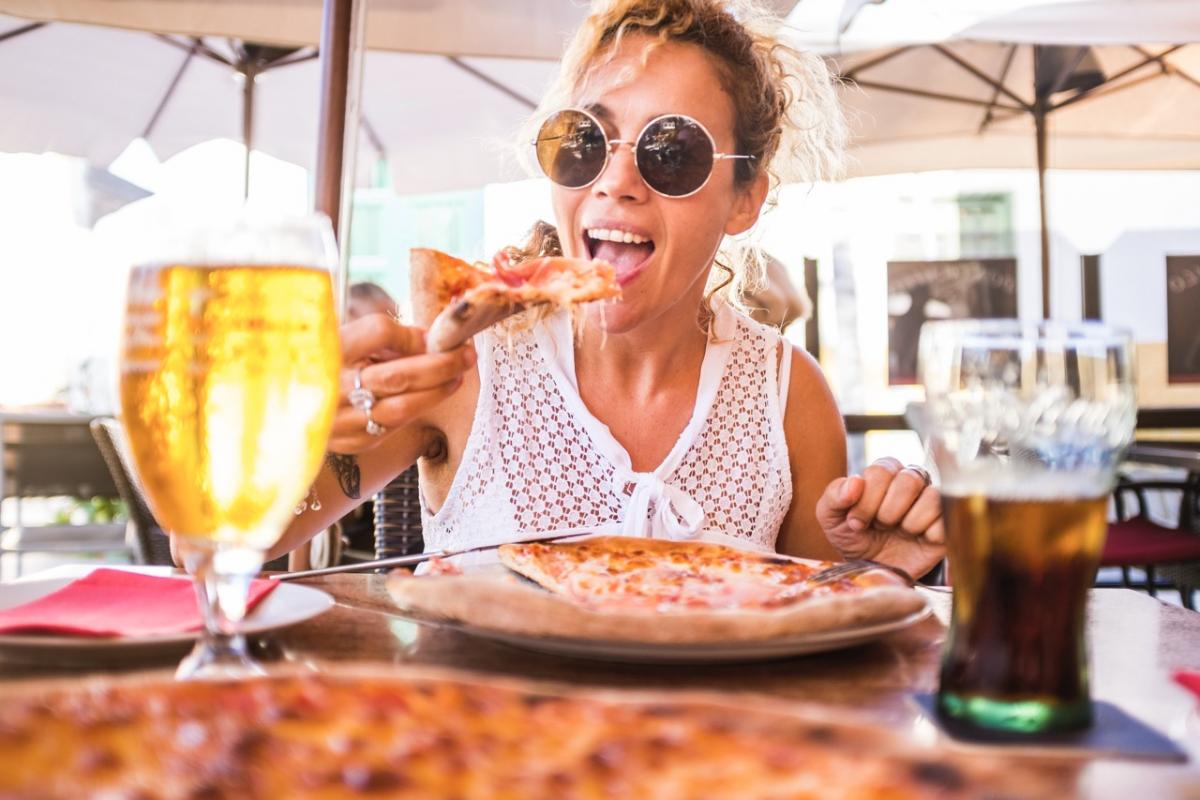 Turista disfrutando de una comida al sol en una terraza de Tenerife durante el otoño europeo.