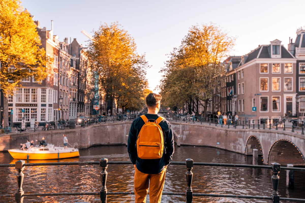 Un joven de espaldas frente al canal de Ámsterdam