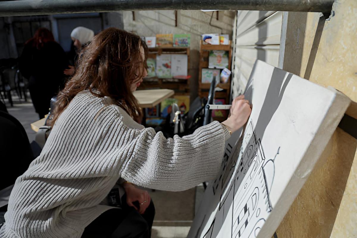 Una mujer dibujando en un lienzo en blanco