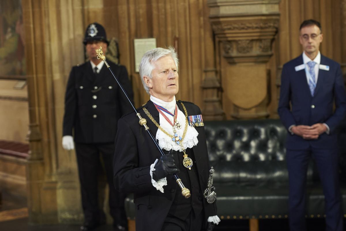 El caballero ujier de la Vara Negra, David Leakey, camina por el vestíbulo central del Palacio de Westminster hacia la Cámara de los Comunes para convocar a los miembros del parlamento para escuchar el discurso de la Reina durante la apertura estatal del Parlamento el 21 de junio de 2017 en Londres, Reino Unido.