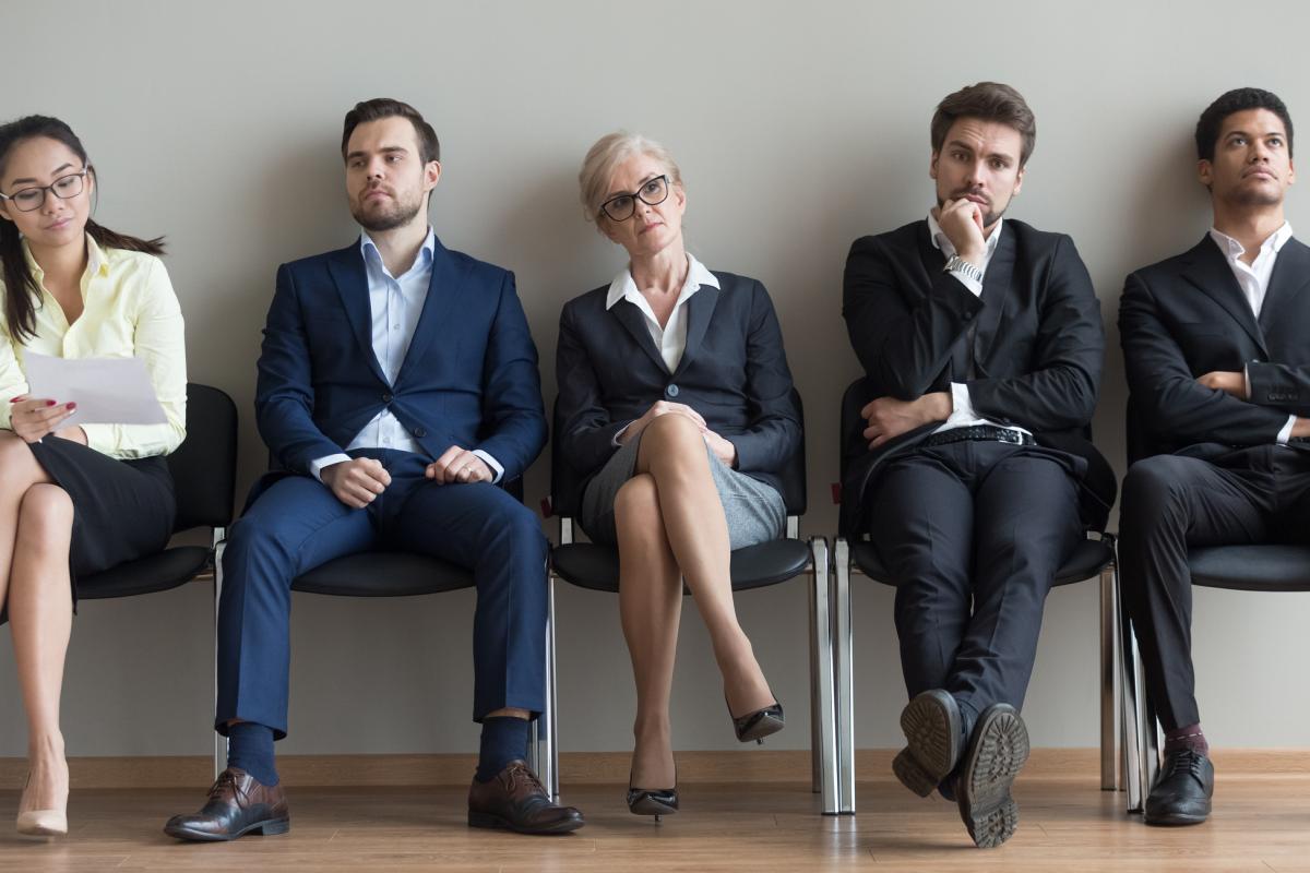 Diversos aspirantes a la espera de su turno, preparación para entrevista de trabajo