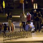 Family and friends wait outside Gateway High School where witnesses were brought for questioning after a shooting at a movie theater showing the Batman movie "The Dark Knight Rises," Friday, July 20, 2012 in Aurora, Colo. A gunman wearing a gas...