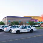 Police cars are seen in the parking area around the Century 16 movie theater in Aurora, Colorado, July 20, 2012 where a gunman opened fire during the showing of the new Batman movie. At least 12 people were killed and around 50 wounded in the ci...
