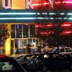 Police are pictured outside of a Century 16 movie theatre where as many as 12 people were killed and many injured at a shooting during the showing of a movie at the in Aurora, Colo., Friday, July 20, 2012. (Photo credit: AP Photo/Ed Andrieski)
