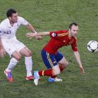 Iniesta se adelanta a Reveillere para controlar el balón.