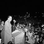 Vice President Nixon points to home-made sign at airport as he arrives in home state to cast his ballot on Nov. 8, 1960 in Ontario, California. (AP Photo)