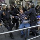 Riot police apprehend a protestor during a general strike in Madrid, Spain, Wednesday, Nov. 14, 2012. Spain's General Workers' Union said the nationwide stoppage, the second this year, was being observed by nearly all workers in the automobile, ...