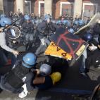 Demonstrators clash with policemen in riot gear during a protest against Italian Government austerity measures in Rome, Wednesday, Nov. 14, 2012. Workers across the European Union sought to present a united front against rampant unemployment and...