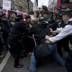 Police officers try to push protesters back onto the pavement after they blocked traffic on Oxford Street, London, whilst taking part in a picket and demonstration they said was over dismissals of 28 workers employed by contractors on the Crossr...
