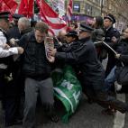 Police officers try to push protesters back onto the pavement after they blocked traffic on Oxford Street, London, whilst taking part in a picket and demonstration they said was over dismissals of 28 workers employed by contractors on the Crossr...