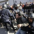 Riot police apprehend a protestor during a general strike in Madrid, Spain, Wednesday, Nov. 14, 2012. Spain's General Workers' Union said the nationwide stoppage, the second this year, was being observed by nearly all workers in the automobile, ...