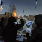 Demonstrators place stickers on a window at shopping centre calling to general strike against government austerity measures, in Pamplona, northern Spain, Wednesday, Nov. 14, 2012. A Spanish Interior Ministry official says 32 people have been arr...
