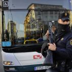 Spanish riot police stands in front of a public bus during a general strike against government austerity measures, in Pamplona, northern Spain, Wednesday, Nov. 14, 2012. A Spanish Interior Ministry official says 32 people have been arrested and ...