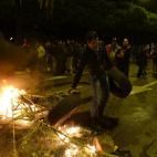 Protesters burn tires at the main entrance to Mercabarna, the biggest wholesale market, during a general strike in Barcelona, Spain, Wednesday, Nov. 14, 2012. Spain's main trade unions will stage a general strike, coinciding with similar work st...