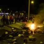 Protesters burn tires at the main entrance to Mercabarna, the biggest wholesale market, during a general strike in Barcelona, Spain, Wednesday, Nov. 14, 2012. Spain's main trade unions will stage a general strike, coinciding with similar work st...