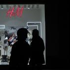 A policeman guards an H&M shop with a graffiti on its front window reading: "Nov. 14 strike" as a man passes by during a general strike in Madrid, Spain, Wednesday, Nov. 14, 2012. Spain's main trade unions stage a general strike, coinciding with...