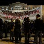 Demonstrators stand outside the Greek Parliament protesting against austerity measures in Athens on November 11, 2012. Thousands of protesters massed outside Greece's parliament Sunday as lawmakers prepared to vote on a 2013 budget that include...