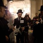 Anti-austerity protesters take part in what they called 'the Plebs & PIIGS Banquet', a demonstration outside the Lord Mayor's Banquet in the City of London, Monday, Nov. 12, 2012. PIIGS is a reference to people from Portugal, Italy, Ireland, Gre...