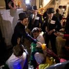 Anti-austerity protesters take part in what they called 'the Plebs & PIIGS Banquet', a demonstration outside the Lord Mayor's Banquet in the City of London, Monday, Nov. 12, 2012. PIIGS is a reference to people from Portugal, Italy, Ireland, Gre...