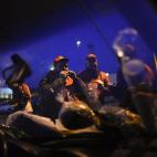 Trade Union members take breakfast early in the morning outside a factory during a general strike against government austerity measures in Pamplona, northern Spain, Wednesday, Nov. 14, 2012. (AP Photo/Alvaro Barrientos)