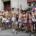 Un grupo de personas esperan que se abran las puertas del comercio.