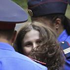 Maria Aliokhina, del grupo de punk ruso 'Pussy Riot', escoltada a su llegada a las dependencias del juzgado de Khamovnichesky antes de la sesión preliminar del juicio el 23 de julio. | EFE
