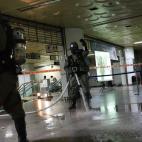 South Korean soldiers spray water to clean out the remnants of poisonous gas on the floor during an anti-terror exercise as part of Ulchi Freedom Guardian exercise, at a subway station in Seoul, South Korea, Wednesday, Aug. 22, 2012. South Korea...
