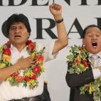 Bolivia President Evo Morales, left, sings the national anthem with Bolivia Ambassador Antolin Ayaviri Gomez during his visit in Bergamo, near Milan, Italy, Thursday, Sept. 5, 2013. (AP Photo/Antonio Calanni)