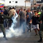 Un militar lanza gas lacrim&oacute;geno cerca de la base militar 'La Carlota' en Caracas.