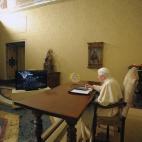 In this photo released by the Vatican newspaper Osservatore Romano, Pope Benedict XVI, seated in his studio at the Vatican City, uses an iPad device to light up one of the world's largest electronic Christmas tree in Gubbio, central Italy, Wedne...