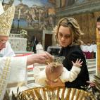 VATICAN CITY, VATICAN - JANUARY 13: Pope Benedict XVI (L) performs a baptism in the Sistine Chapel on January 13, 2013 in Vatican City, Vatican. The Vatican reiterated its opposition to same-sex marriage on January 13, after an Italian court ru...