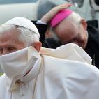 Pope Benedict XVI (L) is greeted by Italian Prime Minister Mario Monti and his wife Elsa (both not pictured) as he disembarks from a helicopter in Arezzo stadium on the start of a one day pastoral visit on May 13, 2012. The Pope will lead a Holy...