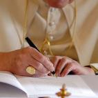 VATICAN CITY, ITALY - NOVEMBER 30: Pope Benedict XVI signs his second encyclical of his pontificate November 30, 2007 in Vatican City. The 70-page encyclical is titled in Latin 'Spe Salvi facti sumus' (In Hope We Are Saved). (Photo by L'Osser...